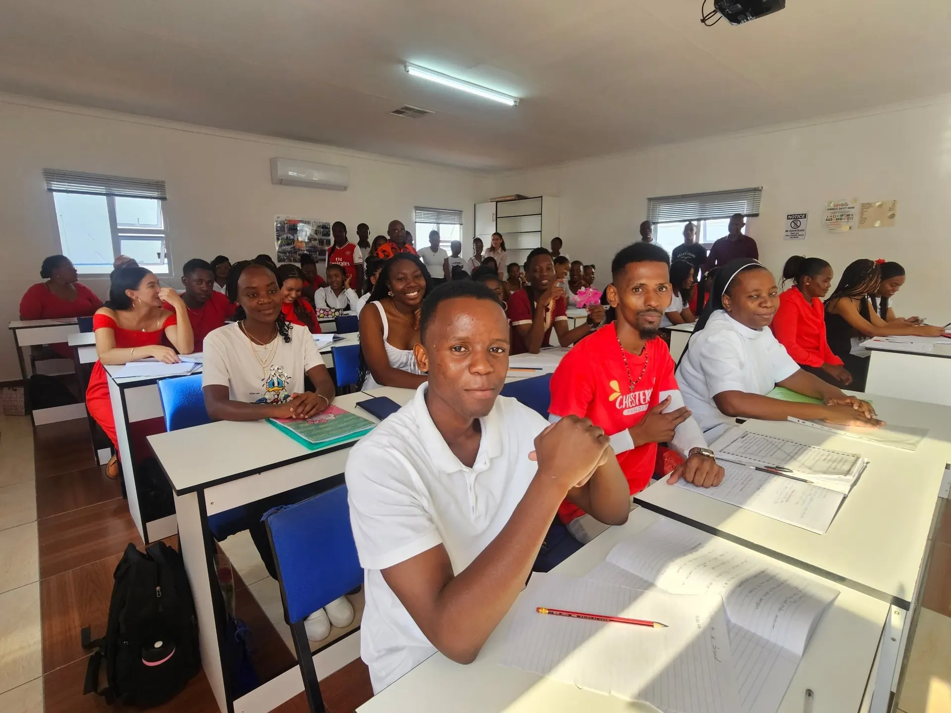 PMT students in a bright classroom with projector.