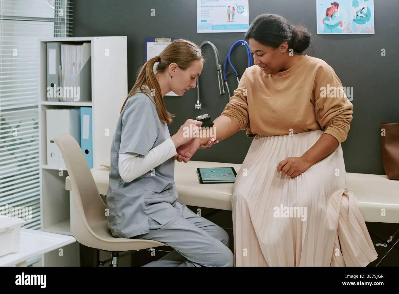 Nurse checking patient blood pressure.