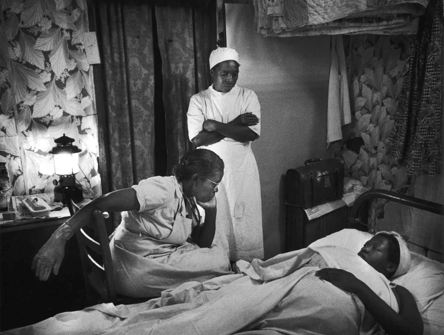 Nurse attending to a patient in a care setting.