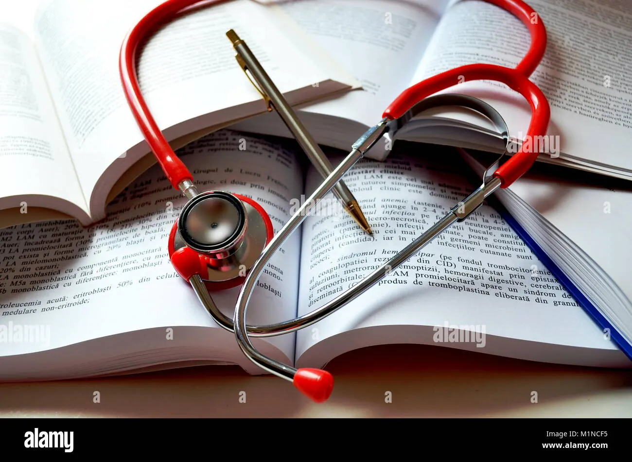 Medical textbooks and stethoscope on a study desk.